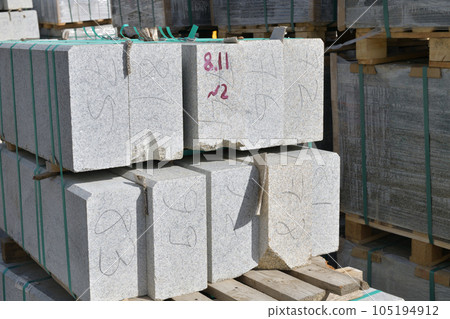 Granite curbstones in stacks prepared for road repair 105194912