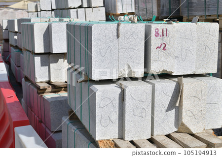 Granite curbstones in stacks prepared for road repair 105194913