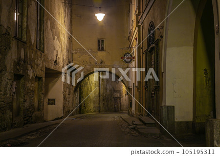 Vilnius old town street illuminated at night, Lithuania, Baltics Vilnius old town street illuminated at night, Lithuania, Baltics 105195311