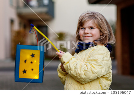 Little Preschool Kid Girl Holding Selfmade Traditional Lanterns with Candle for St. Martin Procession. Child Happy about Children and Family Parade in Kindergarten. German Tradition Martinsumzug. Little Preschool Kid Girl Holding Selfmade Traditional Lanterns with Candle for St. Martin Procession. Child Happy about Children and Family Parade in Kindergarten. German Tradition Martinsumzug. 105196047