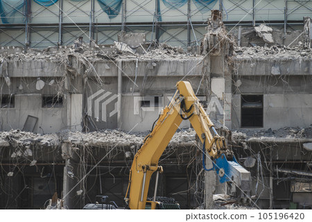 Heavy machinery removing building structures and rubble Heavy machinery removing building structures and rubble 105196420