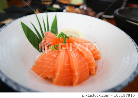 raw salmon, sashimi or sliced salmon or salmon sashimi 105197910