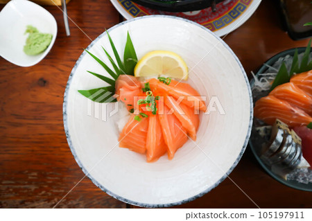 raw salmon, sashimi or sliced salmon or salmon sashimi 105197911