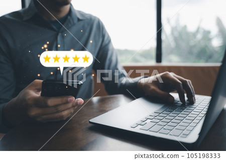 Client feedback is essential for business growth. A man's hand holding a laptop and smartphone with a 5-star rating icon for service excellence and satisfaction survey Client feedback is essential for business growth. A man's hand holding a laptop and smartphone with a 5-star rating icon for service excellence and satisfaction survey 105198333