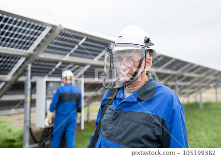Mature Service Engineer man standing in front of solar panels. Technician maintenance solar cells on Solar Energy Plant under morning sunlight. Technology solar energy renewable Mature Service Engineer man standing in front of solar panels. Technician maintenance solar cells on Solar Energy Plant under morning sunlight. Technology solar energy renewable 105199382