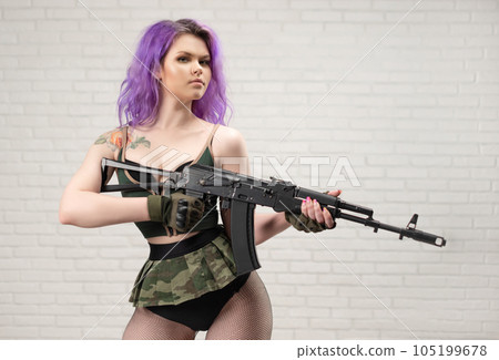 sexy girl with pink hair in a short skirt miliriti with an airsoft gun on a white background of a brick wall sexy girl with pink hair in a short skirt miliriti with an airsoft gun on a white background of a brick wall 105199678