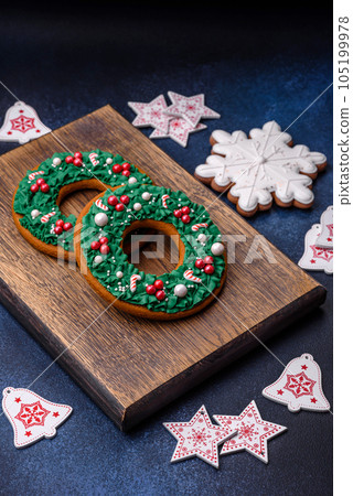 Beautiful festive Christmas gingerbread made by hand with decoration elements Beautiful festive Christmas gingerbread made by hand with decoration elements 105199978