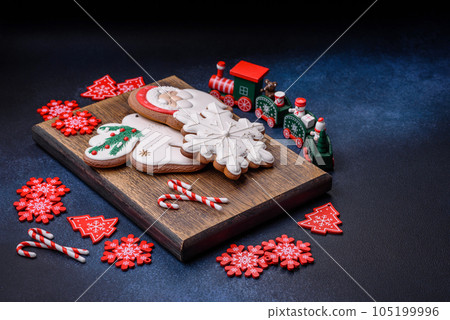 Beautiful festive Christmas gingerbread made by hand with decoration elements Beautiful festive Christmas gingerbread made by hand with decoration elements 105199996