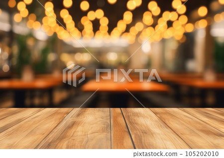 The empty wooden table top with blur background of restaurant. Exuberant. The empty wooden table top with blur background of restaurant. Exuberant. 105202010