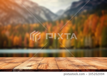 The empty wooden table top with blur background of lake and mountain in autumn. Exuberant. The empty wooden table top with blur background of lake and mountain in autumn. Exuberant. 105202094