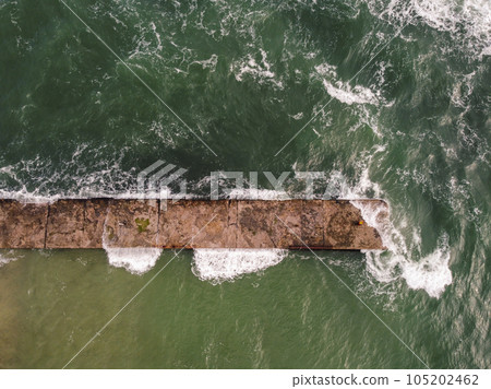 photo captures an oblong concrete pier jutting out into a blue sea Odessa photo captures an oblong concrete pier jutting out into a blue sea Odessa 105202462