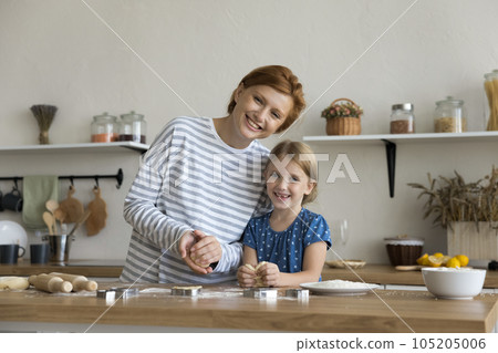 Happy child girl and loving mom enjoying family culinary hobby Happy child girl and loving mom enjoying family culinary hobby 105205006