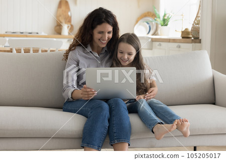 Positive mother and sweet preschool kid girl using computer Positive mother and sweet preschool kid girl using computer 105205017