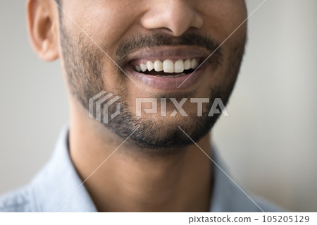 Toothy smile of happy dark skinned man showing white teeth 105205129