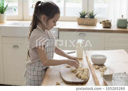 Pretty sweet preschooler kid girl wearing apron cooking bakery meal 105205260