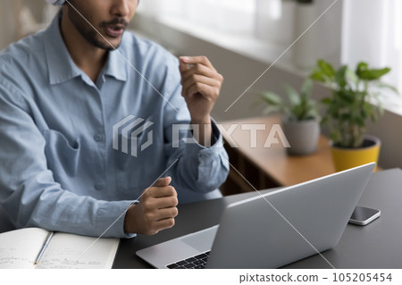 Young Indian online teacher man speaking at laptop 105205454
