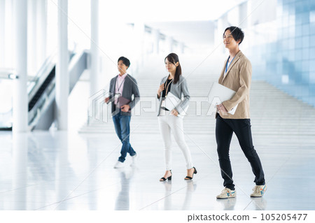 Young male and female engineers working in the office 105205477