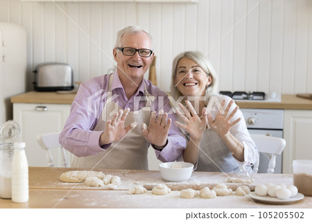 Happy older retired couple enjoying bakery food preparation 105205502