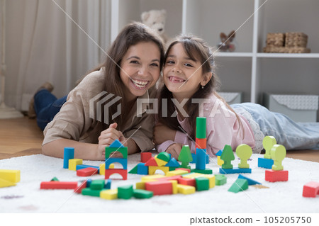 Cheerful young mom and cute positive little daughter girl Cheerful young mom and cute positive little daughter girl 105205750