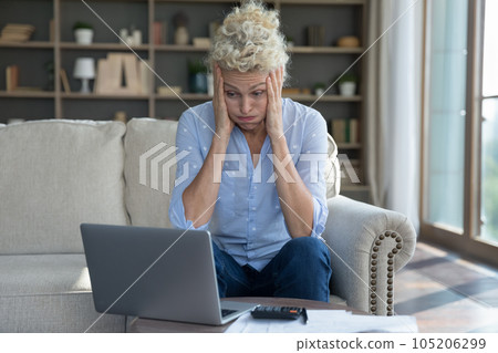 Frustrated concerned mature elder woman worried about finance problems 105206299