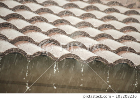 rain falling down from the house roof 105208236