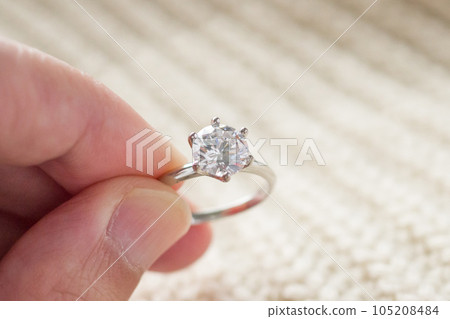 hand hold beautiful jewelry diamond ring 105208484