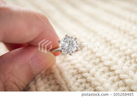 hand hold beautiful jewelry diamond ring 105208485