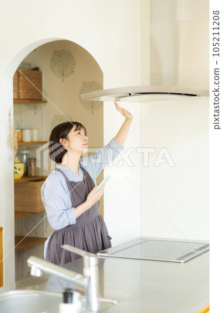 A woman checking the ventilation fan A woman checking the ventilation fan 105211208