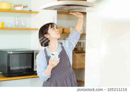 A woman checking the ventilation fan 105211210