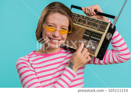 Woman using retro tape record player to listen music disco dancing of favorite track having fun 105211319