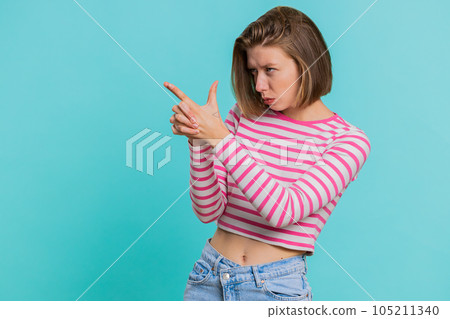 Woman pointing around with finger gun gesture, shooting killing with hand pistol right on target 105211340
