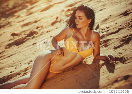 Young sexy woman on sand 105211906