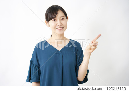 Middle-aged woman pointing to the right White background Middle-aged woman pointing to the right White background 105212113