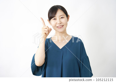 Middle-aged woman pointing to the left White background Middle-aged woman pointing to the left White background 105212115