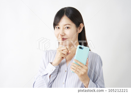 A middle-aged woman holding a smartphone and posing in secret White background 105212221