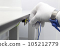 Bracelet on the hand of a man wearing ESD cloth and glove static resistance ESD bracelet or ground equipment, anti-static, used to safely ground is working. Semiconductor manufacturing. 105212779
