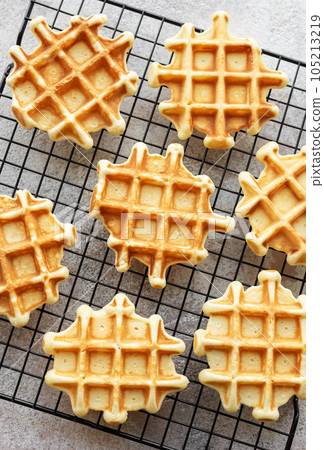 Freshly baked waffles on a baking rack. Freshly baked waffles on a baking rack. 105213219