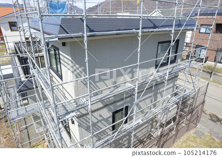 House renovation House in the process of painting the outer wall and replacing the roof (aerial view) 105214176