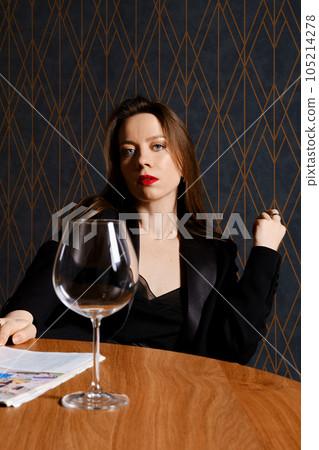 Portrait of stylish woman with empty wine glass Portrait of stylish woman with empty wine glass 105214278