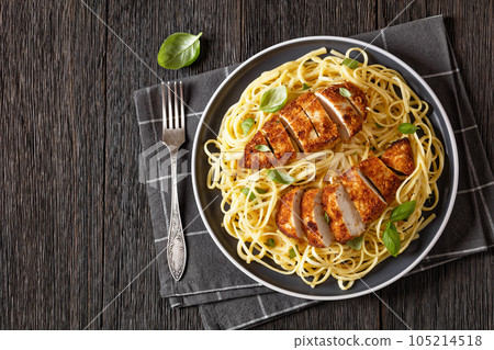 crusted chicken over lemon butter pasta, top view crusted chicken over lemon butter pasta, top view 105214518