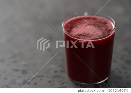 Glass of berry juice on concrete countertop with copy space 105214974