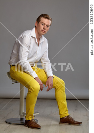 Full length portrait of a ginger guy in white shirt posing on gray background. Sincere emotions. 105215646