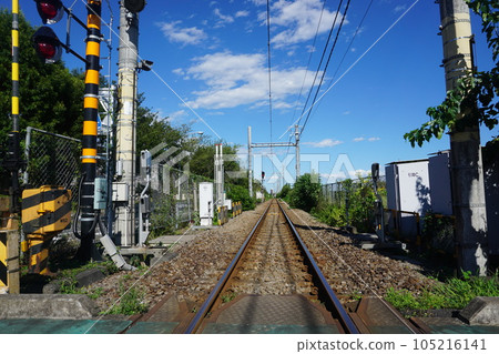 A single track seen from a railroad crossing 105216141