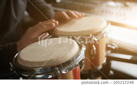 Musician playing hand drum Musician playing hand drum 105217248