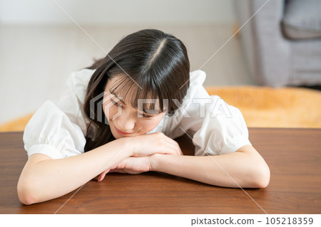 A young woman relaxing on a wooden table A young woman relaxing on a wooden table 105218359