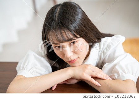 A young woman relaxing on a wooden table A young woman relaxing on a wooden table 105218362