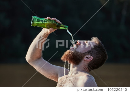 Drinking beer at the beach enthusiastically Drinking beer at the beach enthusiastically 105220240