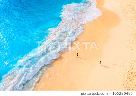 An aerial view of the people on the beach. Coast as a background from top view. An aerial view of the people on the beach. Coast as a background from top view. 105220495