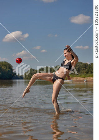 Girl at the beach running into the water Girl at the beach running into the water 105221800