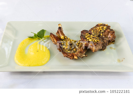 Delicious Italian grilled lamb chop with pistachios topping and sauces Delicious Italian grilled lamb chop with pistachios topping and sauces 105222181